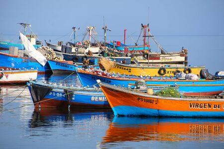 Colorful fishing boats anchored in Paracas Bay, Peru. Paracas is a small port town catering to tourists visiting Paracas Reserve and Ballestas islands.のeditorial素材