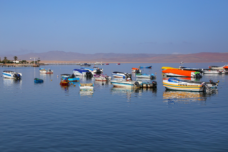 Small motorboats anchored in Paracas Bay, Peru. Paracas is a small port town catering to tourists visiting Paracas Reserve and Ballestas islands.のeditorial素材