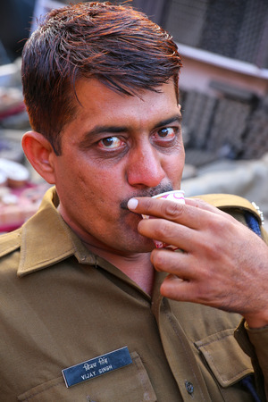 Portrait of policeman drinking chai at Johari Bazaar street in Jaipur, Rajasthan, India. Jaipur is the capital and the largest city of Rajasthan.のeditorial素材