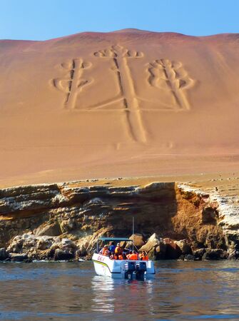 Tourist group in a boat near Candelabra of the Andes in Pisco Bay, Peru. Candelabra is a well-known prehistoric geoglyph found on the northern face of the Paracas Peninsulaのeditorial素材
