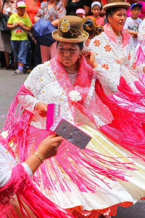 Local women dancing during Festival of the Virgin de la Candelaria in Lima, Peru. The core of the festival is dancing and music performed by different dance schools.のeditorial素材