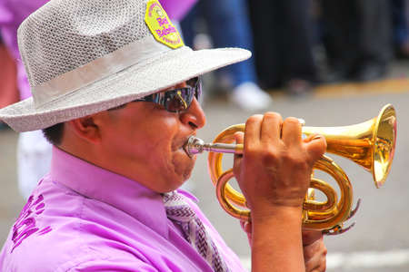 Close up of a local man playing trumpet during Festival of the Virgin de la Candelaria in Lima,...