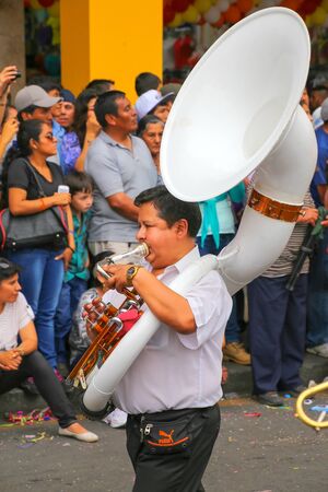 Local man playing sousaphone during Festival of the Virgin de la Candelaria in Lima, Peru. The core of the festival is dancing and music performed by different dance schools.のeditorial素材
