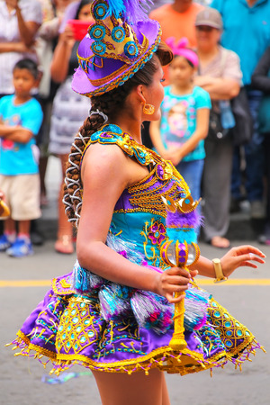 Young local woman dancing during Festival of the Virgin de la Candelaria in Lima, Peru. The core of the festival is dancing and music performed by different dance schools.のeditorial素材