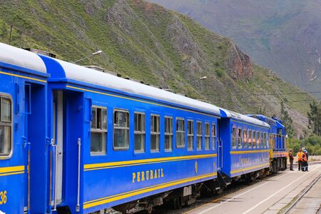 Perurail carriages for locals at the train station in Ollantaytambo, Peru. Local trains to Machu Picchu are equipped with wooden seats and available to Peruvian nationals only for a cheaper price.のeditorial素材
