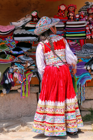 Girl in traditional dress standing at the market in Maca village in Colca Canyon, Peru. Maca is one of the three main tourist towns of the Colca Canyon.のeditorial素材