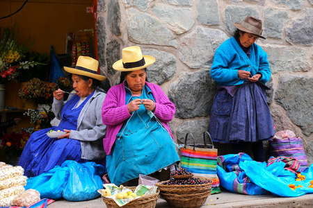Local women sitting at the market in Ollantaytambo, Peru. Ollantaytambo was the royal estate of Emperor Pachacuti who conquered the region.のeditorial素材