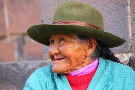 Portrait of a local woman sitting in the street of Cusco, Peru. In 1983 Cusco was declared a World...