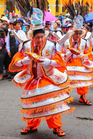 Local men dancing during Festival of the Virgin de la Candelaria in Lima, Peru. The core of the festival is dancing and music performed by different dance schools.のeditorial素材