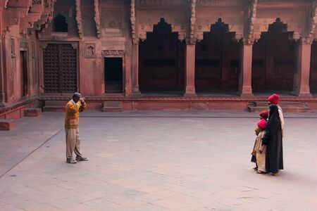 Visitors taking pictures in Jahangiri Mahal in Agra Fort, Uttar Pradesh, India. The fort was built primarily as a military structure, but was later upgraded to a palace.のeditorial素材