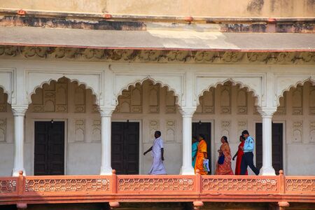 People walking in colonnade walkway leading to Diwan-i- Khas, Agra Fort, Uttar Pradesh, India. The...