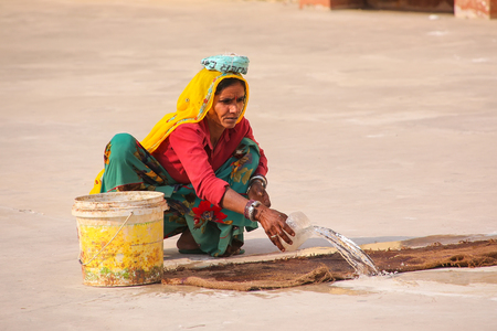 Local woman working in the second courtyard of Amber Fort near Jaipur, Rajasthan, India. Amber Fort is the main tourist attraction in the Jaipur area.のeditorial素材