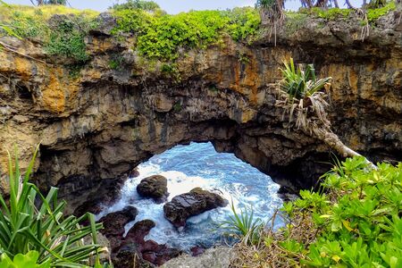 Natural land bridge Hufangalupe on the southern part of Tongatapu island in Tonga. It was formed when the roof of a sea cave collapsedの写真素材