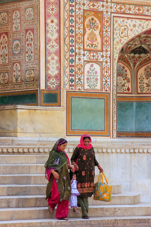 Local women going down the stairs at Ganesh Pol,  Amber Fort, Rajasthan, India. Ganesh Pol was a gateway to the maharaja's appartments.のeditorial素材