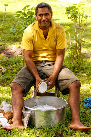 Local man scraping coconuts in Lavena village,  Taveuni Island, Fiji. Taveuni is the third largest island in Fiji.のeditorial素材