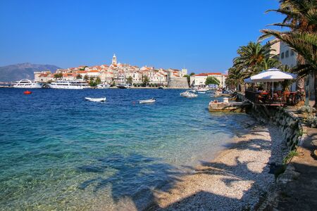 Clear water at the waterfront of Korcula town, Croatia. Korcula is a historic fortified town on the protected east coast of the island of Korculaの写真素材