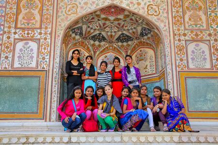 Group of young women gathering at Ganesh Pol in Amber Fort, Rajasthan, India. Ganesh Pol was a gateway to the maharaja's appartments.のeditorial素材