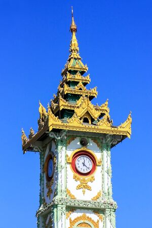 Close view of Clock tower at Mahamuni Pagoda complex in Mandalay, Myanmar. Mahamuni Pagoda is a Buddhist temple and major pilgrimage site in Myanmar.の写真素材