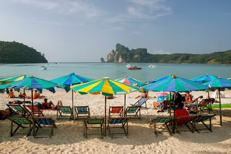 Umrellas and sunchairs at Ao Loh Dalum beach on Phi Phi Don Island, Krabi Province, Thailand. Koh Phi Phi Don is part of a marine national park.のeditorial素材