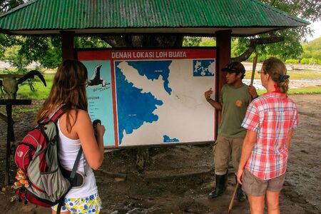 Guide talking to tourists at the visitor center on Rinca island, Komodo National Park, Indonesia.のeditorial素材