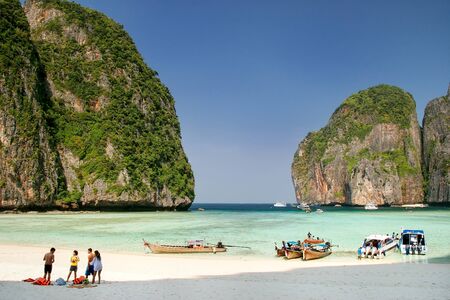 Tourists and longtail boats at Maya Bay on Phi Phi Leh Island, Krabi Province, Thailand. It is part of Mu Ko Phi Phi National Park.のeditorial素材