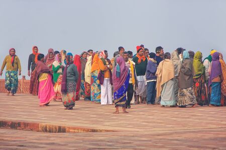 Group of people walking at Taj Mahal complex in Agra, Uttar Pradesh, India. Taj Mahal was designated...