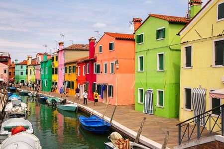 Colorful houses by canal in Burano, Venice, Italy. Burano is an island in the Venetian Lagoon and is known for its lace work and brightly colored homes.のeditorial素材