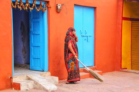 Local woman sweeping yard in Taj Ganj neighborhood of Agra, Uttar Pradesh, India. Agra is one of the most populous cities in Uttar Pradeshの写真素材