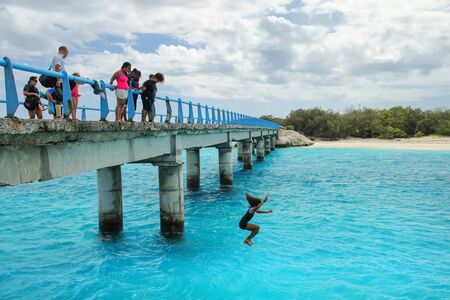 Local kids jumping off the Mouli Bridge between Ouvea and Mouli islands, Loyalty Islands, New Caledonia. The population of Ouvea Island is about 3400 people.のeditorial素材