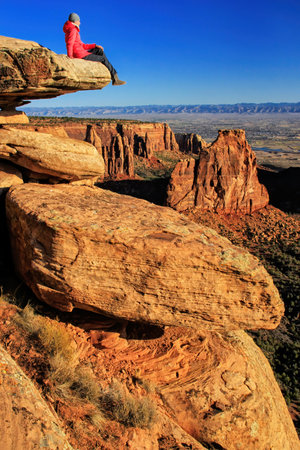 Hiker injoying the view of  Monument Canyon, Colorado National Monument, Grand Junction, USAの写真素材