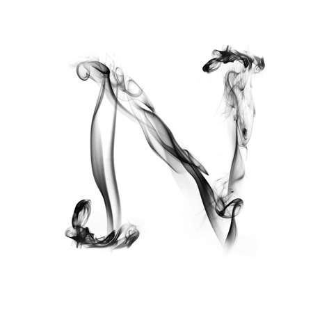 one letter from a smoky alphabet isolated on white backgroundの写真素材