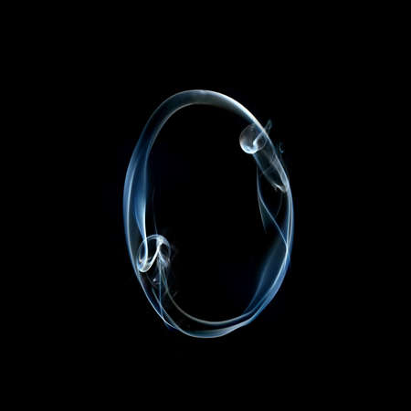 one letter from a smoky alphabet isolated on blackの写真素材