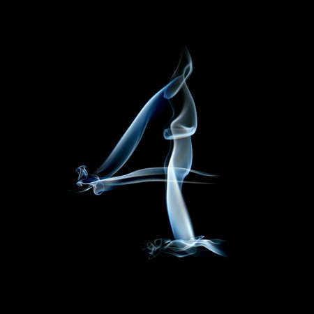 one letter from a smoky alphabet isolated on blackの写真素材
