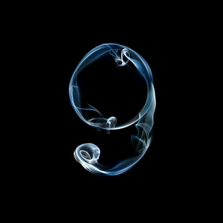 one letter from a smoky alphabet isolated on blackの写真素材