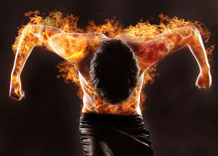 fiery silhouette of athletic manの写真素材