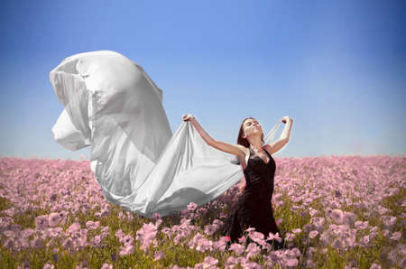 young pretty girl in the flower fieldの写真素材