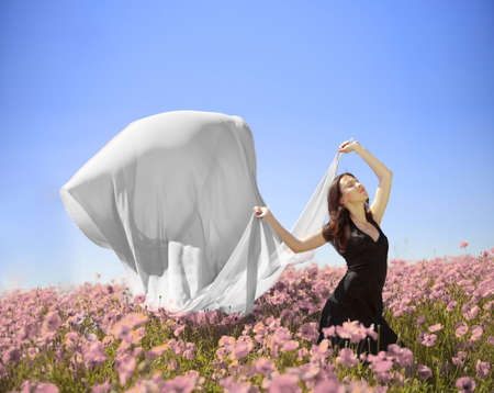 young pretty girl in the flower fieldの写真素材
