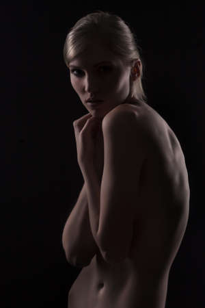 beautiful nude woman on black backgroundの写真素材