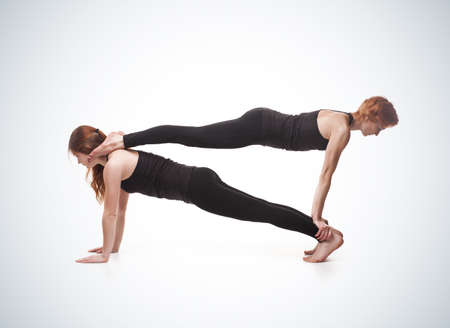 paired yoga on a blue background