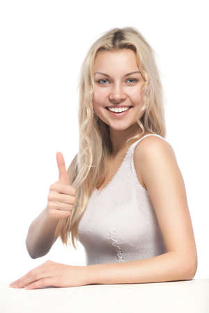 attractive blonde woman showing thumbsupの写真素材