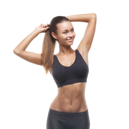 Smiling beautiful woman doing exercise isolated on white backgroundの写真素材