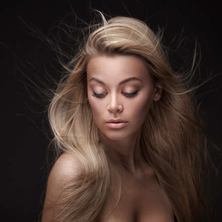 Beautiful Woman with Straight Long Hair on black backgroundの写真素材