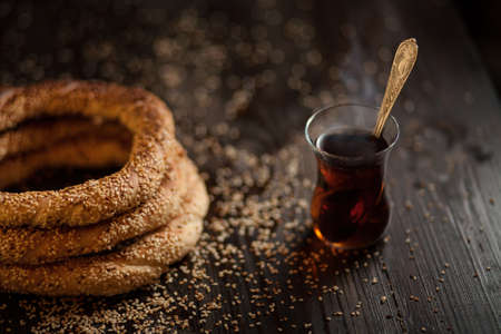 traditional Turkish bagels with sesame seeds on dark wooden background