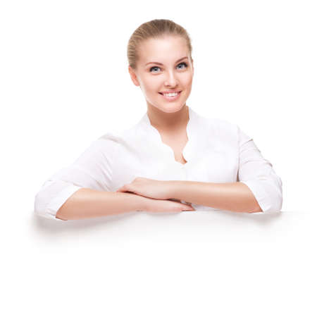studio shot of beautiful young smiling woman isolated over white backgroundの写真素材