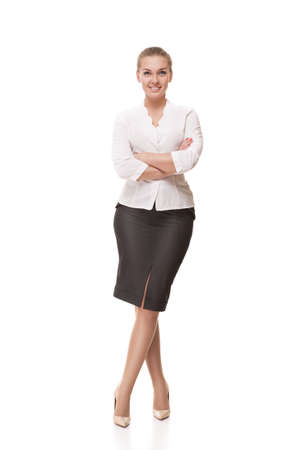 Successful business woman with arms crossed isolated over whiteの写真素材