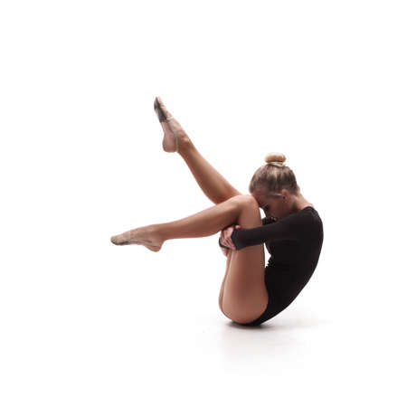 studio shoot of cute woman gymnast isolated on white backgroundの写真素材