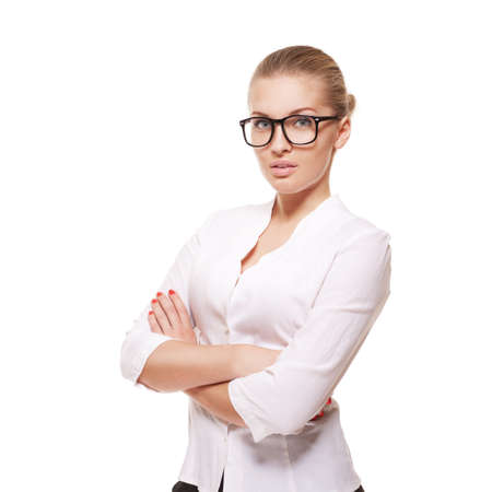 Successful business woman in glasses with arms crossed isolated over whiteの写真素材