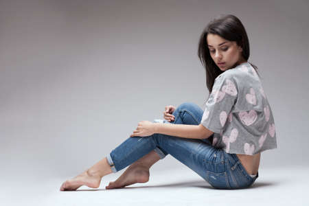 portrait of sexy woman posing on light studio backgroundの写真素材