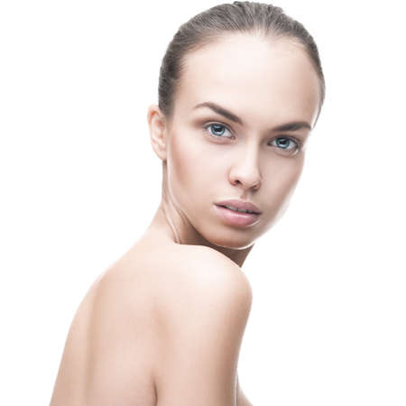 Beautiful face of young  woman with clean fresh skin isolated over whiteの写真素材