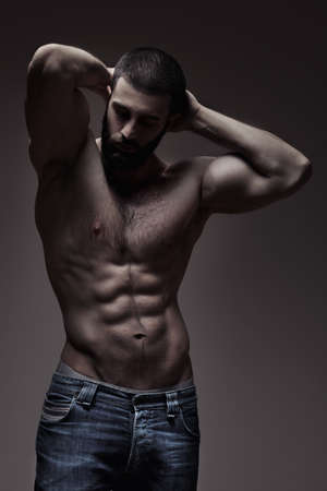 strong athletic man on dark grey gradient backgroundの写真素材